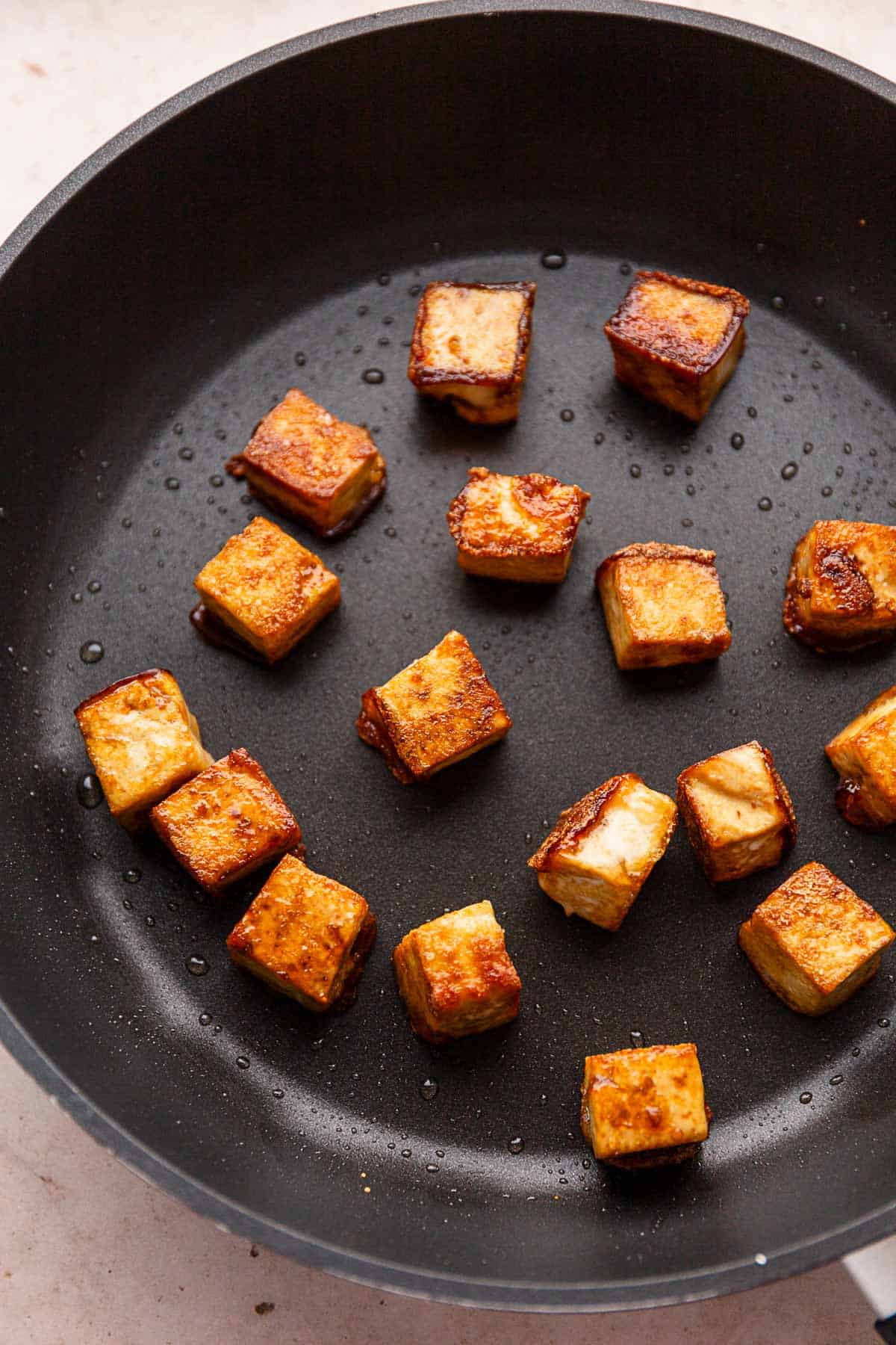 fried tofu in skillet.