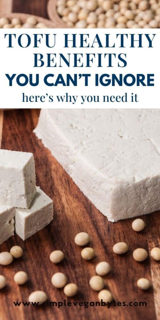 Block and cubes of tofu on a wooden surface, surrounded by scattered soybeans, with text saying "TOFU HEALTH BENEFITS YOU CAN'T IGNORE here's why you need it"