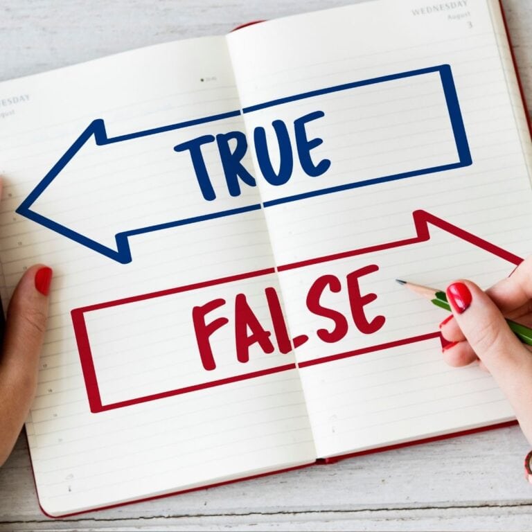 Open notebook showing blue “TRUE” and red “FALSE” arrows, representing facts versus myths.