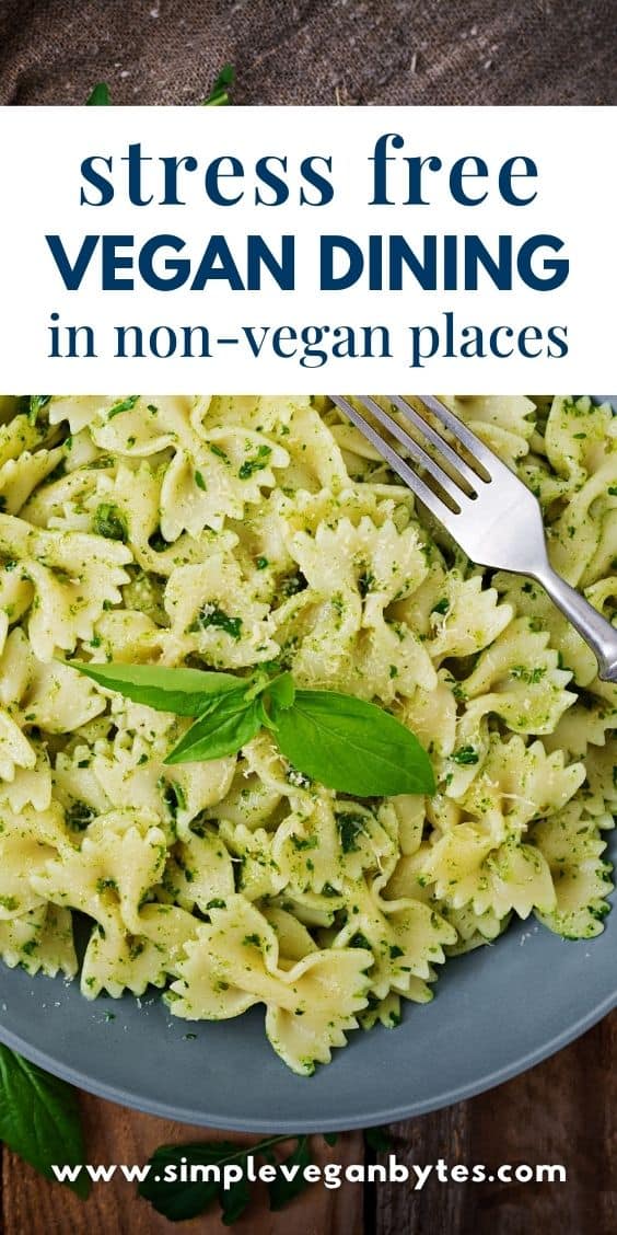 Vegan bow tie pasta on a gray plate with a fork on the side, with text 'Stress-Free Dining in Non-Vegan Places'