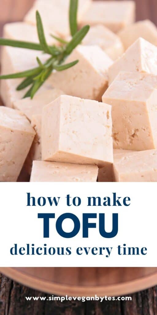 cubed tofu on a wooden plate with text 'how to make tofu delicious every time'
