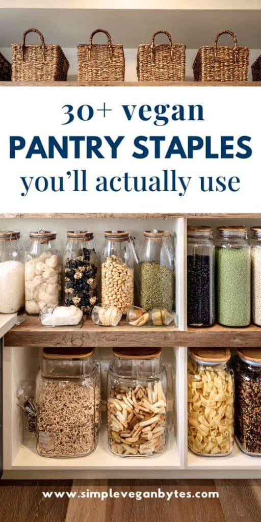 Close-up shot of a well-organized, white wooden pantry shelf, displaying dried vegan staples in clear glass jars with bamboo lids. Above the shelf are woven straw baskets. The image has a text overlay reading: "30+ vegan pantry staples you'll actually use."