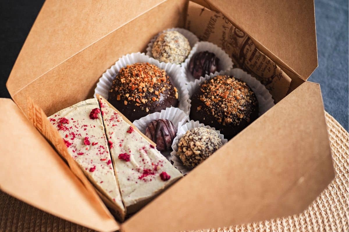 Vegan chocolate truffles and plant-based sweets in a kraft gift box