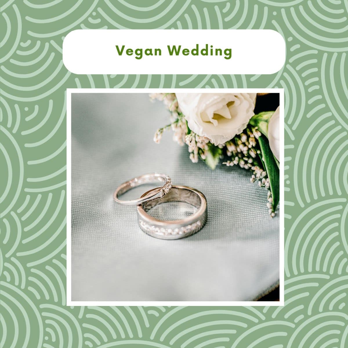 Close-up of wedding rings on a white table beside a bouquet of white flowers