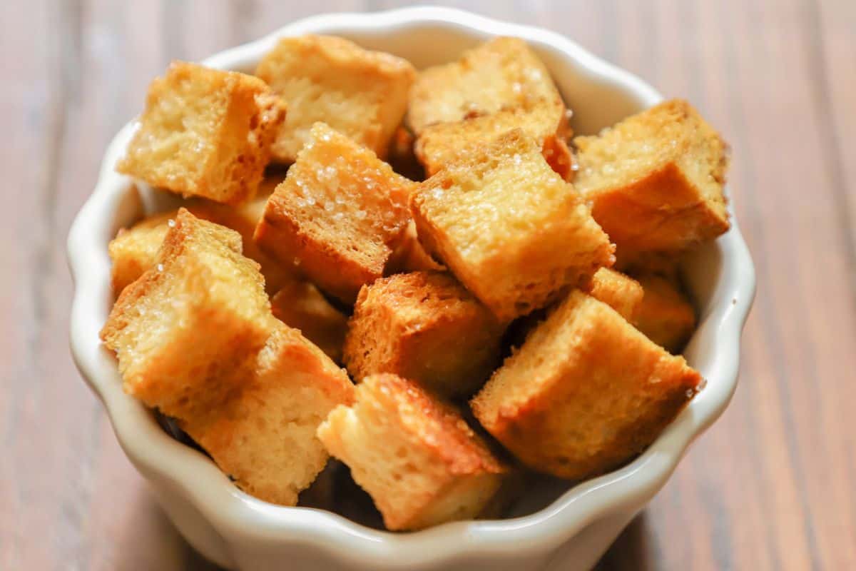 Crispy baked tofu cubes served in a small white bowl