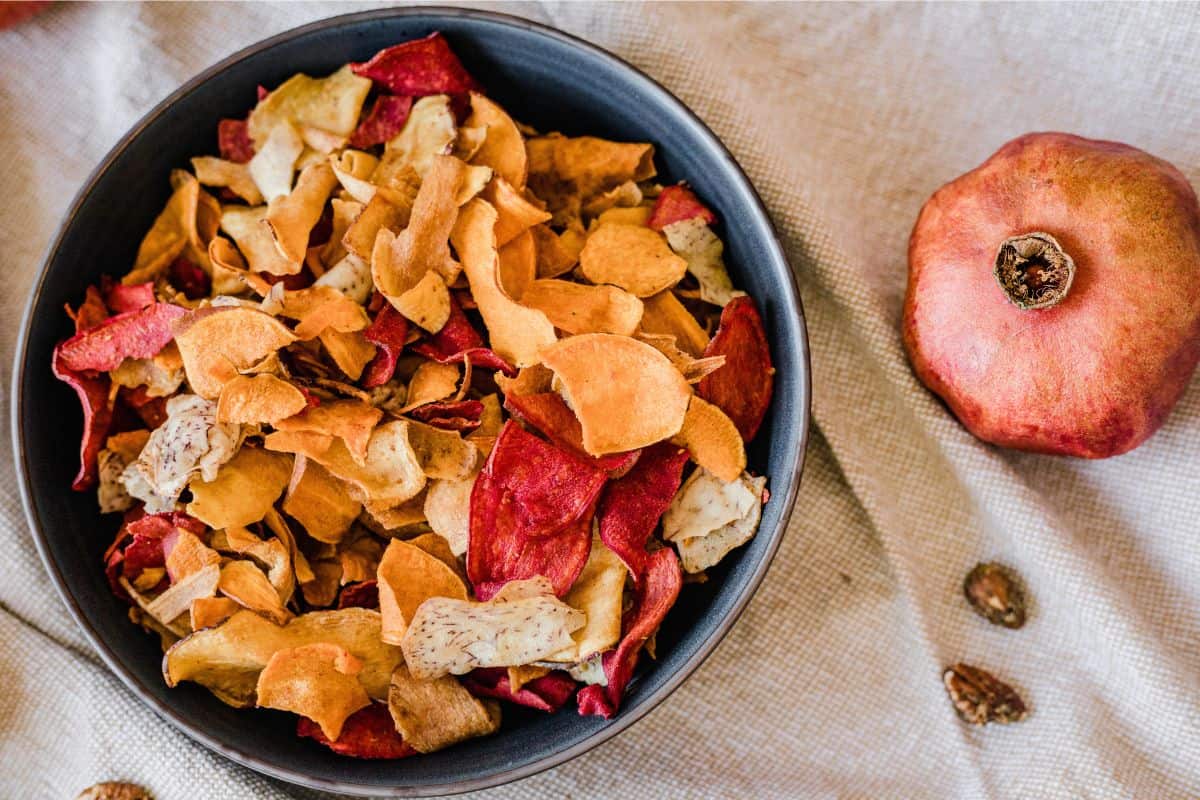 Bowl of dried fruit chips and vegan snack mix
