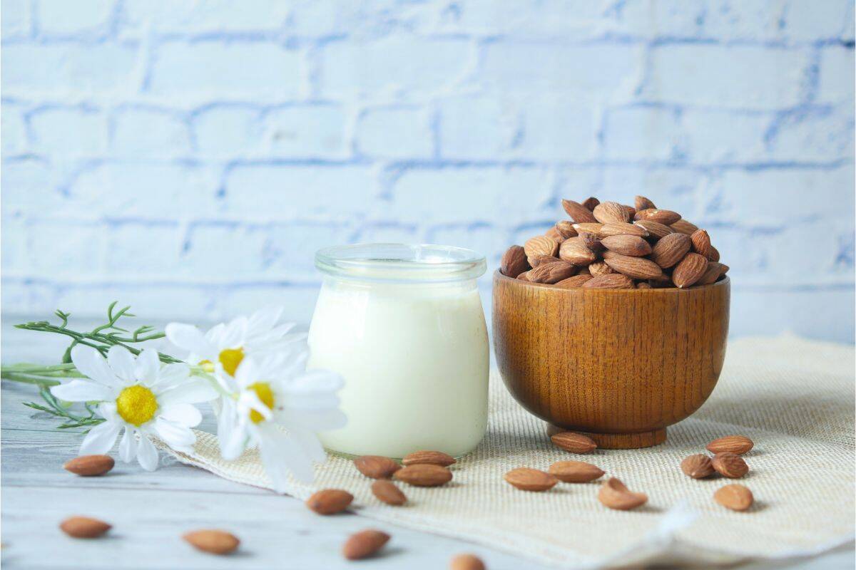 Bowl of raw almonds on a light background, commonly used in plant-based milk and vegan recipes.