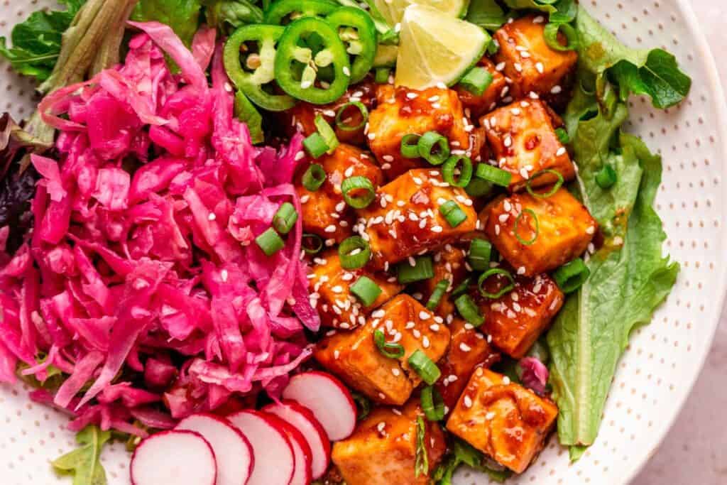 Crispy tofu stir fry with garlic sauce, pickled cabbage, and fresh vegetables