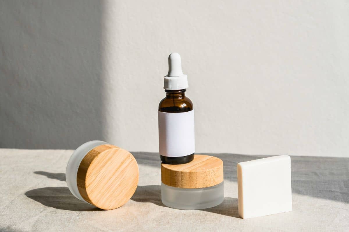 Minimalist skincare set with dropper bottle and soap on neutral background