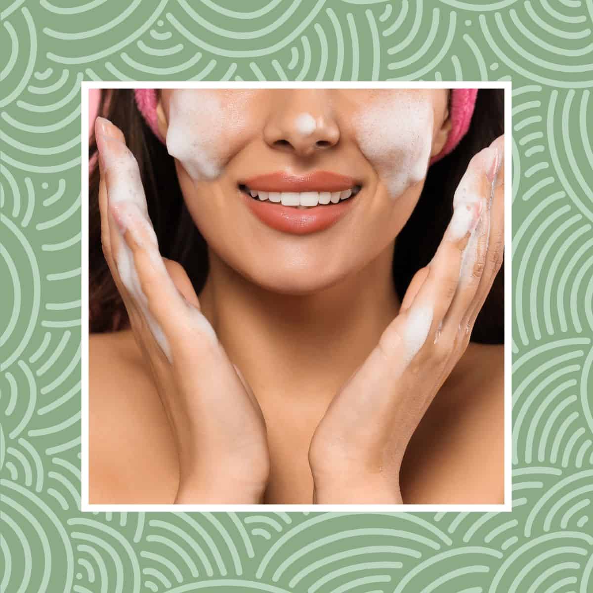 Woman cleansing face with gentle foam and smiling close-up.