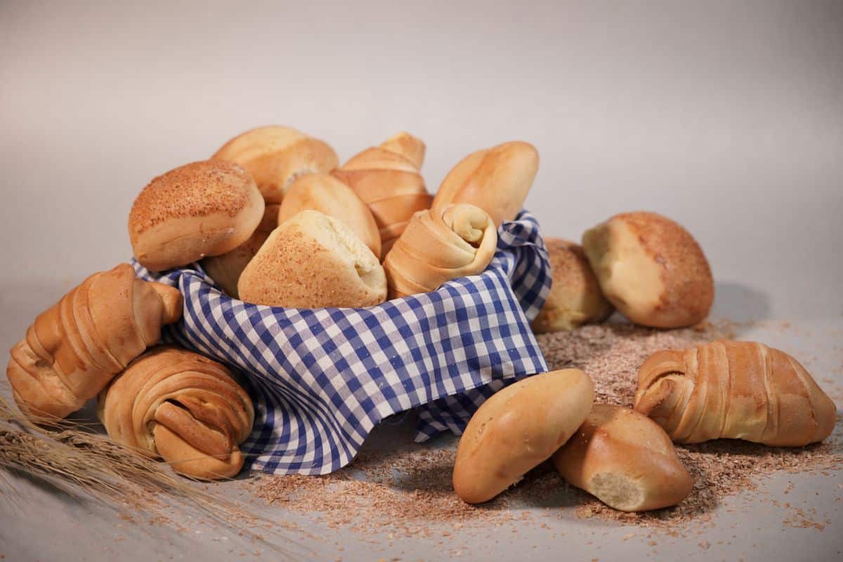 Basket filled with assorted bread rolls and croissants