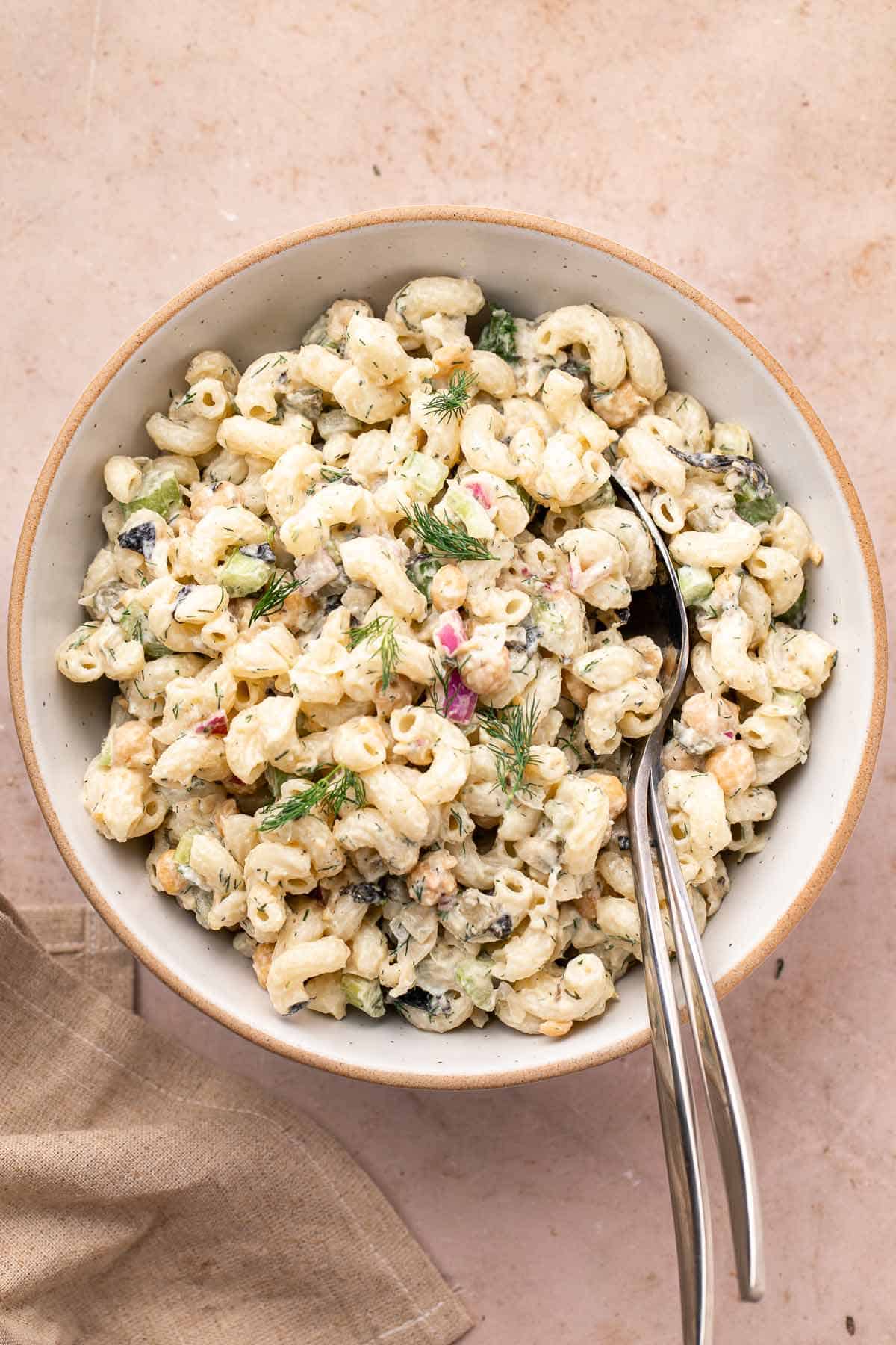 Vegan pasta salad with chickpeas, dill, and celery in a ceramic bowl