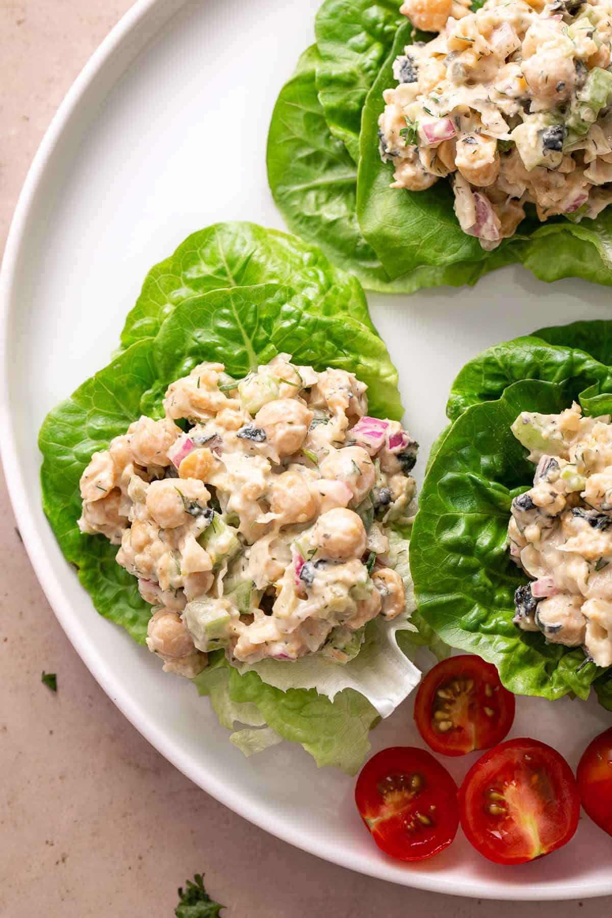 Chickpea salad in lettuce cups with fresh lemon slices