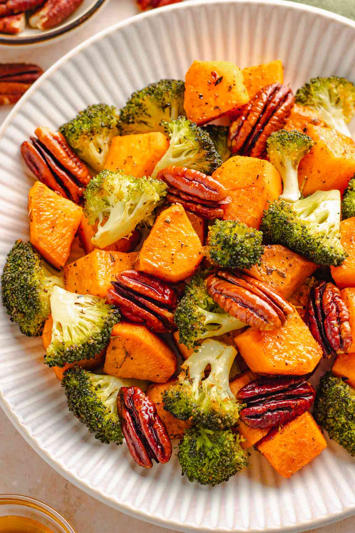 Bowl of roasted sweet potatoes, broccoli, and toasted pecans