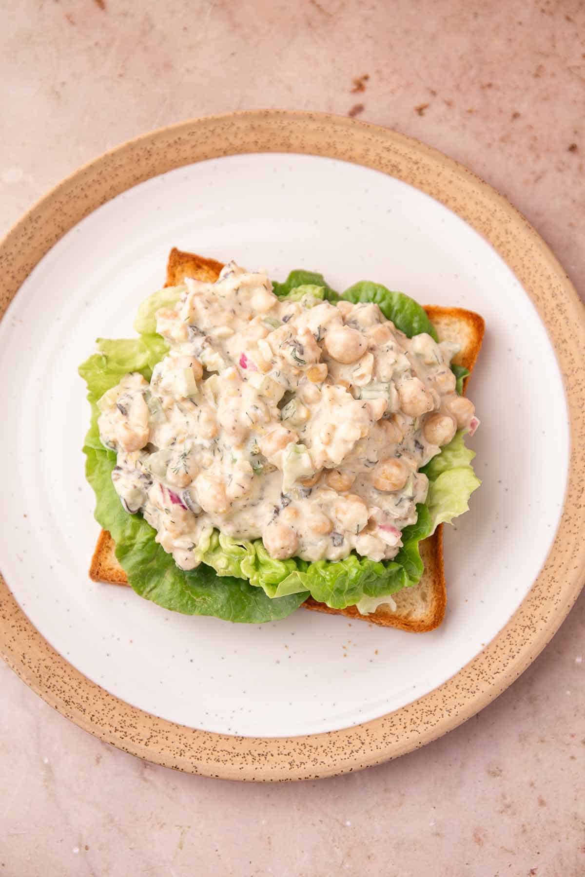 Open-faced sandwich with lettuce and creamy chickpea salad filling
