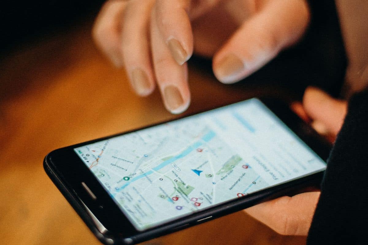 Person using a smartphone map to navigate while traveling