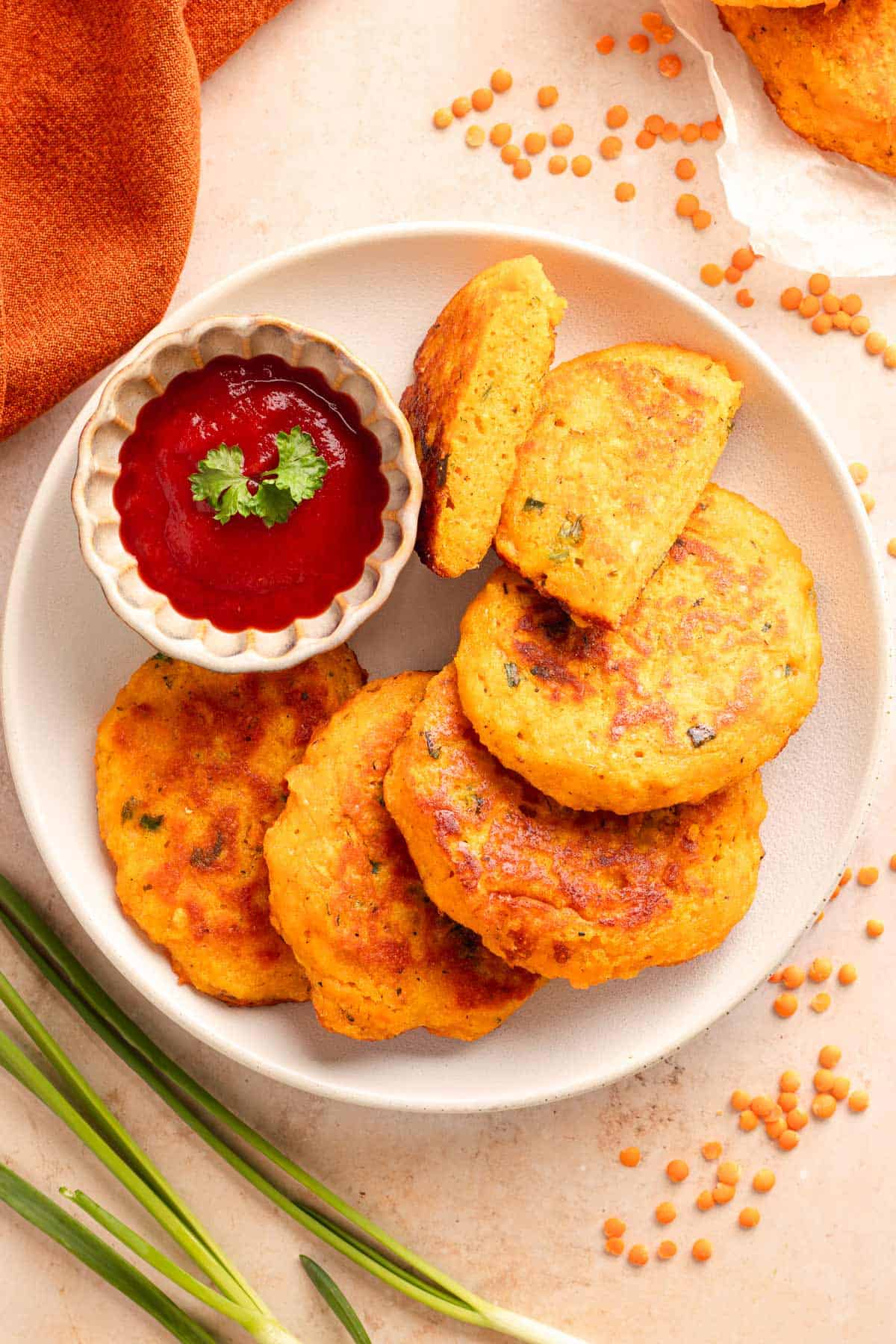 Plate of crispy sweet potato lentil fritters served with ketchup