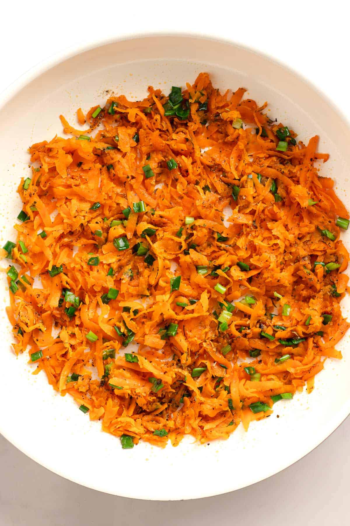 Seasoned grated sweet potato mixed with herbs and green onions