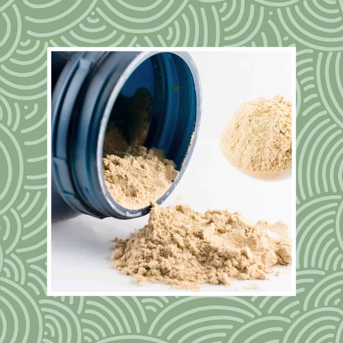 Protein powder spilling from an open container with a scoop of powder on a white background.