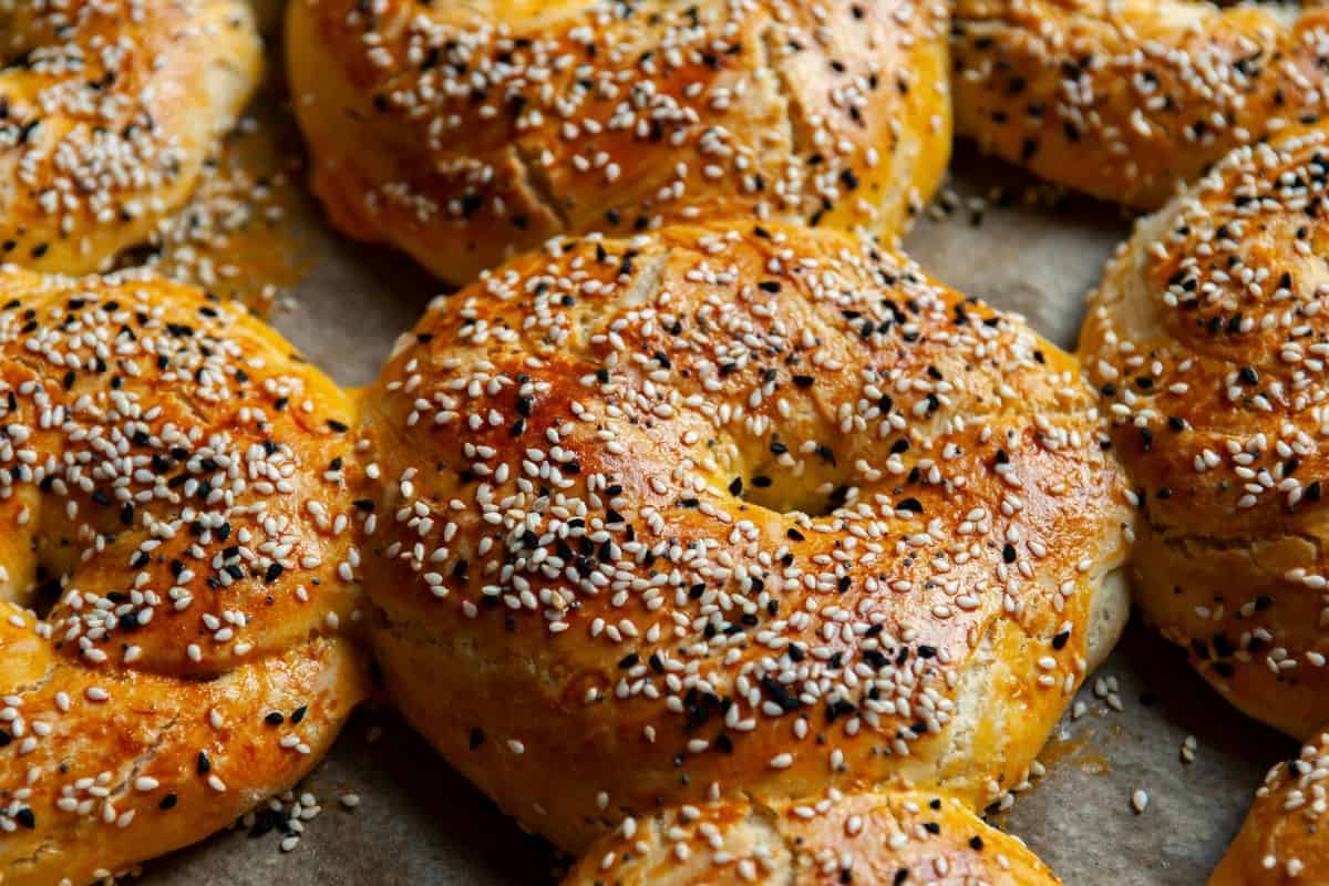 Freshly baked bagels topped with sesame and other seeds.