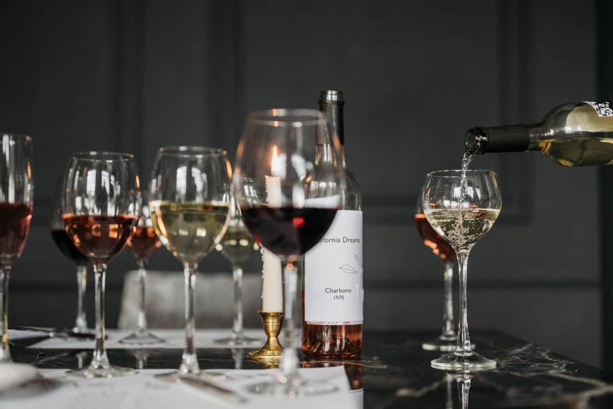 Wine glasses and bottles arranged for a wine tasting.