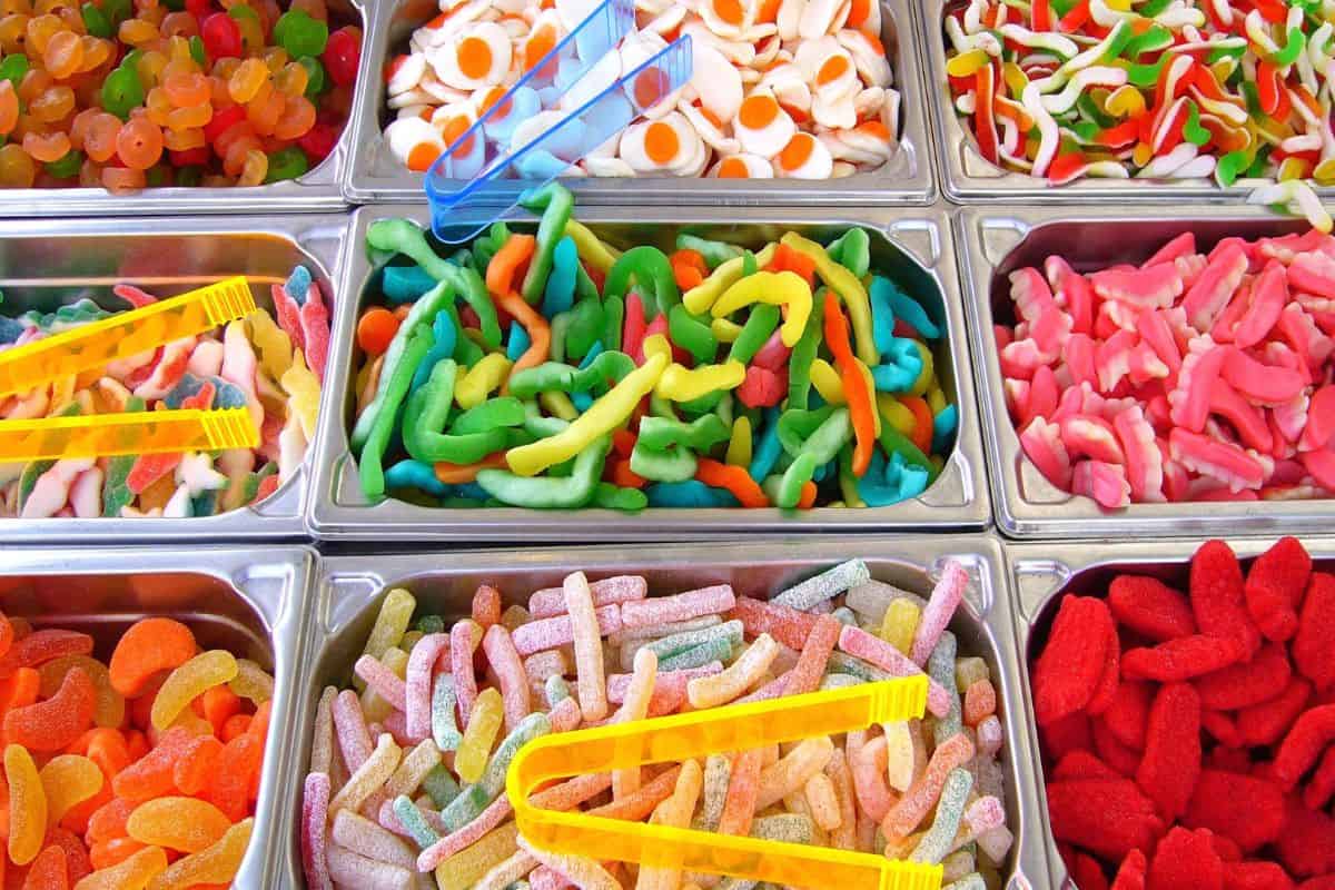 Colorful assortment of gummy candies displayed in store bins.