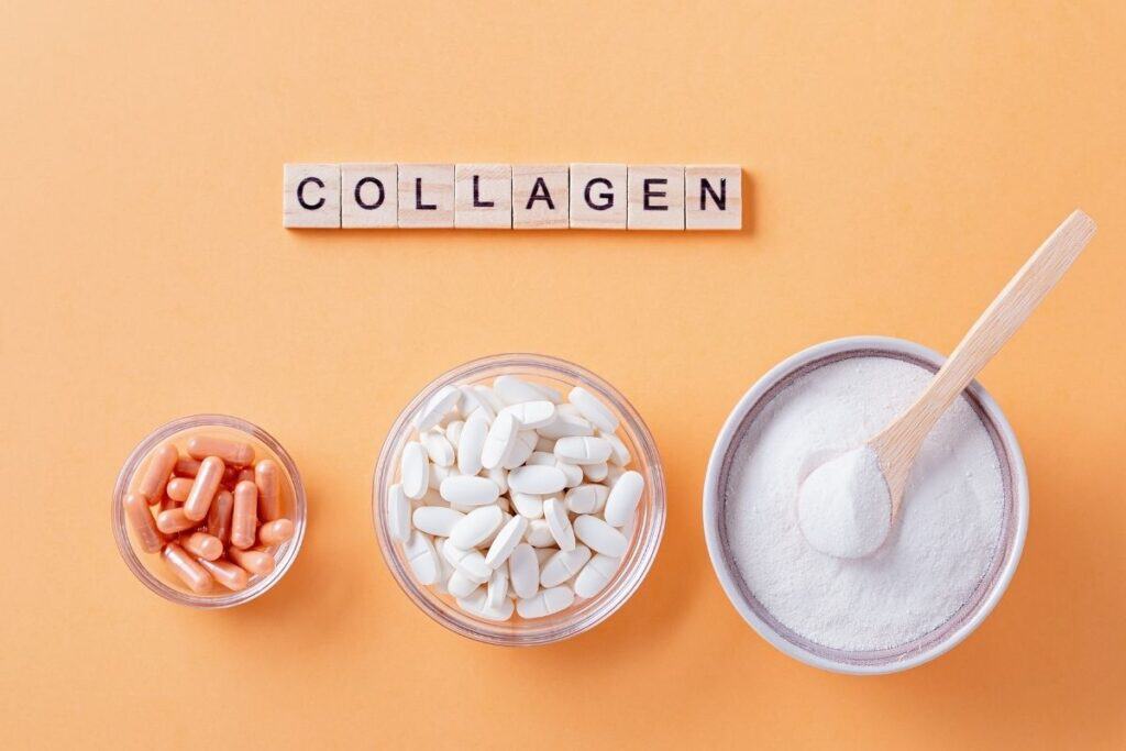 Collagen powder, capsules, and tablets arranged on an orange background with the word “COLLAGEN.”